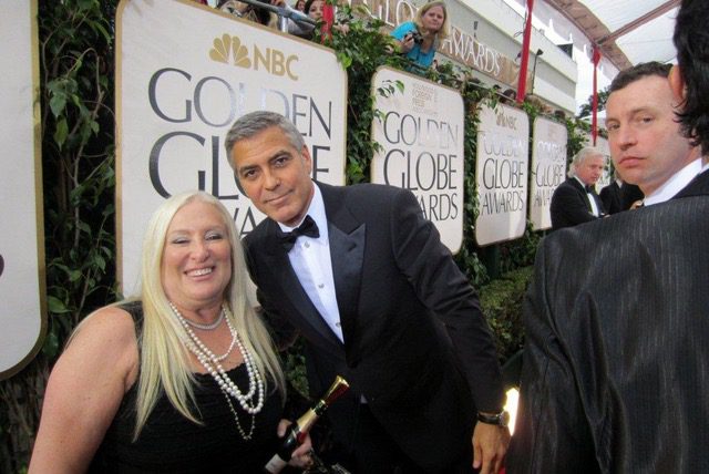 The Brave Files Podcast guest, Linda Smith, poses with George Clooney.